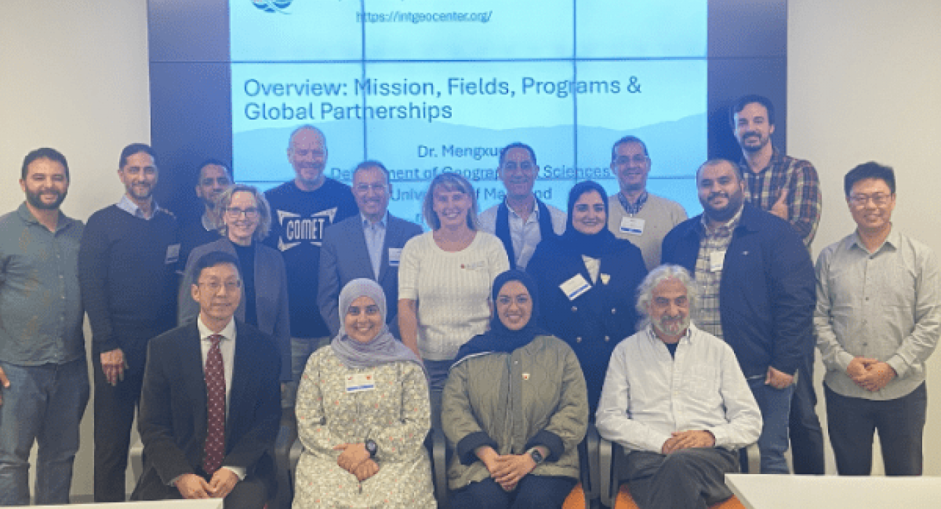 Group photo of MENA Space Leaders visit, posing in front of a large presentation screen.